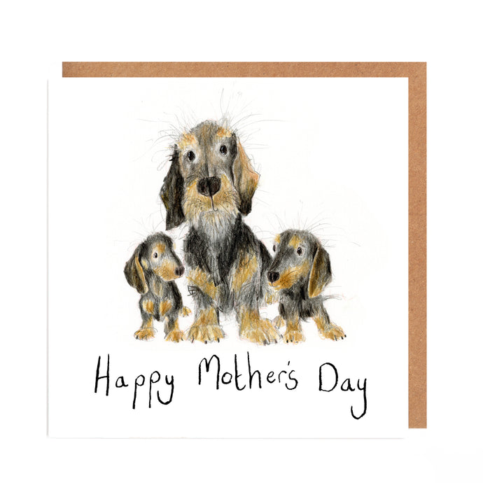 A Mother's Day Card featuring a watercolour pencil illustration of a mummy and baby dachshunds with handwritten 'Happy Mother's Day' message underneath. 