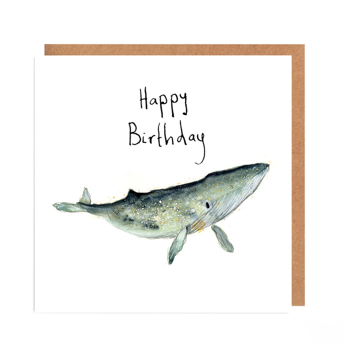 Birthday card featuring blue and gold watercolour and ink illustration of a whale on a white background and handwritten Happy Birthday text