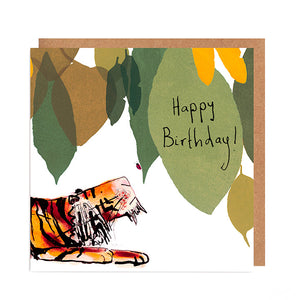 Flatlay of greetings card featuring a tiger looking up at a ladybird on green and yellow leaves, with handwritten Happy Birthday message. 