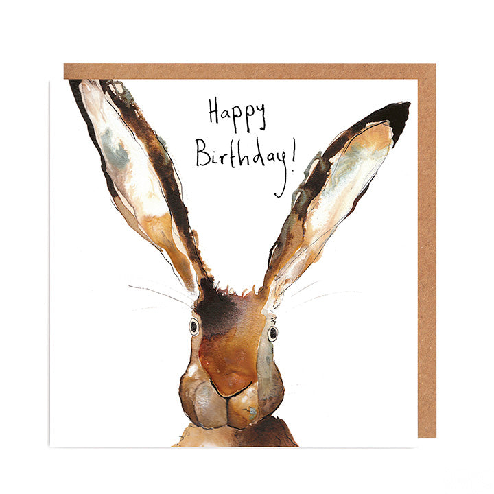 Flatlay of greetings card featuring ink and watercolour illustration of hare with big ears and handwritten Happy Birthday message.