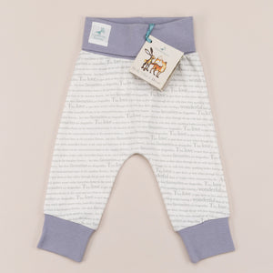 Unisex joggers for babies aged 0-2 years with exclusive Storytime print and  dusky heather trim, laid flat on a cream background.