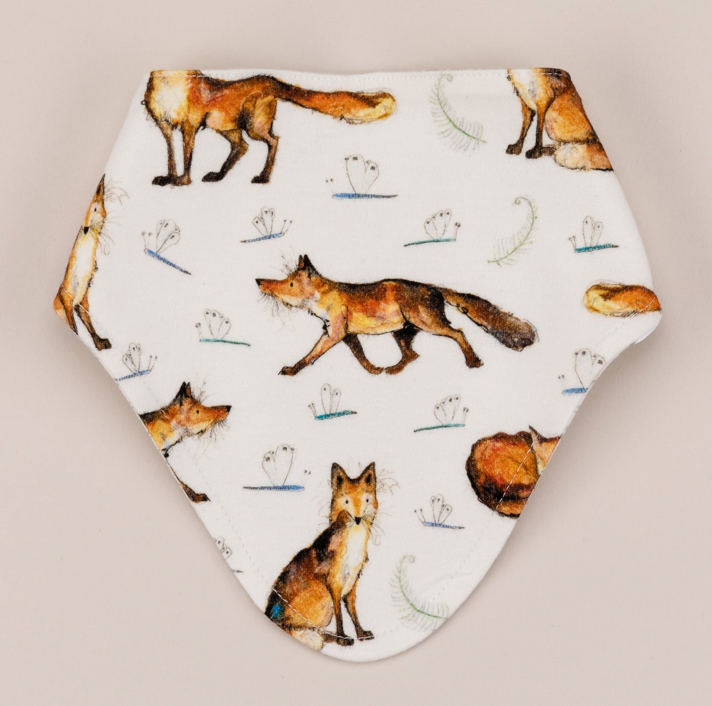 Bandana dribble bib featuring a dexter fox repeat print on a soft white cotton. 