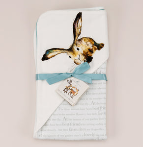 Molly hare wrap blanket folded flat with ribbon and storybook tag
