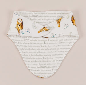 Olive owl bandana bib back, showing story text side. 