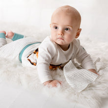 Load image into Gallery viewer, Six month old baby wearing Dexter top and joggers, holding storytime dribble cloth