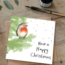 Load image into Gallery viewer, Christmas card featuring robin sitting in a christmas tree laid flat on a wooden table with a matching brown envelope. 