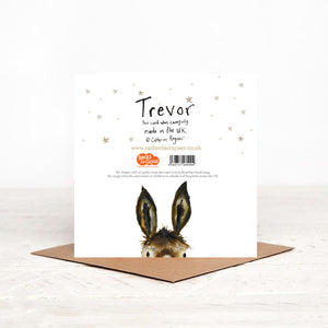 Christmas card stood on matching brown envelope showing the reverse side of Trevor Donkey Christmas card, featuring details of Christmas charity partner children's literacy charity Read for Good.