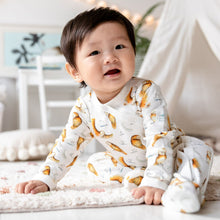 Load image into Gallery viewer, Young toddler smiling sat forward wearing Olive Owl print babygrow