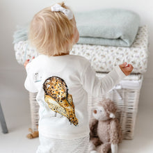 Load image into Gallery viewer, Blonde toddler with arms in the air wearing Olive owl print long-sleeved top showing the reverse side of owl