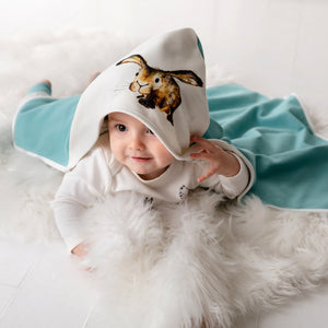 Baby lying down modelling Molly hare hooded blanket